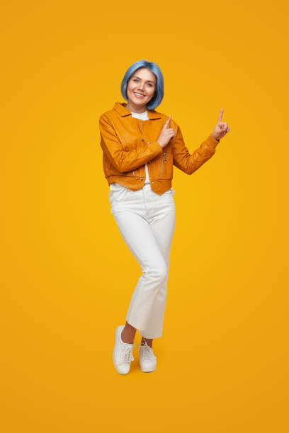 istock Happy hipster woman pointing up 1383176500