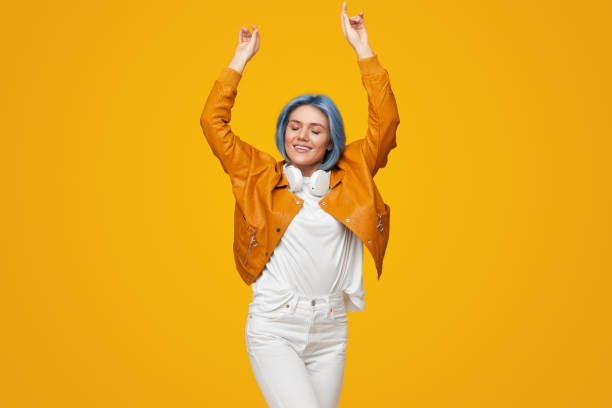 istock Happy woman dancing with raised arms 1383176504