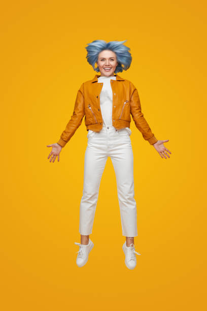 istock Delighted young woman leaping up 1383176512