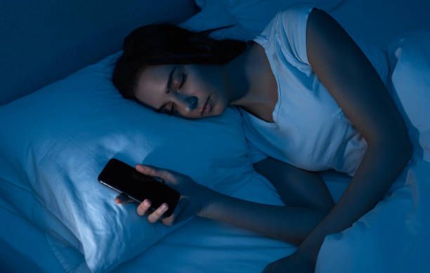 istock Tired woman falling asleep after browsing smartphone 1383176625