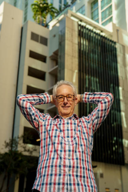 istock Man smiling with arms posed behind his head 1383194197