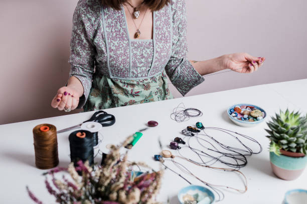istock Young woman creating handmade jewelry in her studio 1383215681