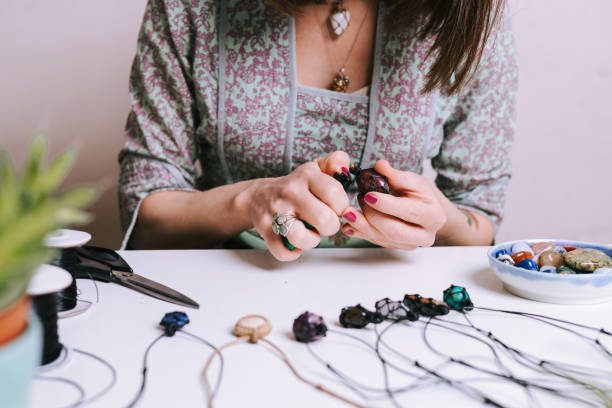 istock Young woman creating handmade jewelry in her studio 1383215699
