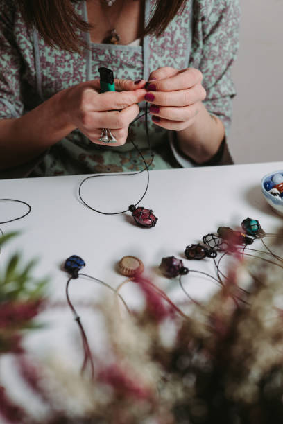 istock Young woman creating handmade jewelry in her studio 1383215713