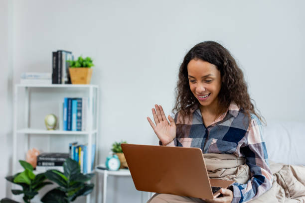 istock Young woman using devices at home. 1383219560