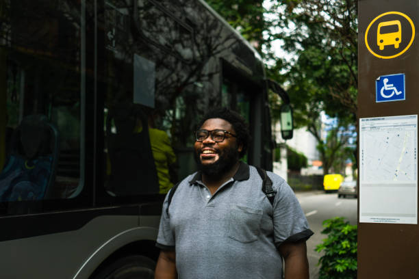 istock Man with vitiligo smiling at a bus station 1383225033
