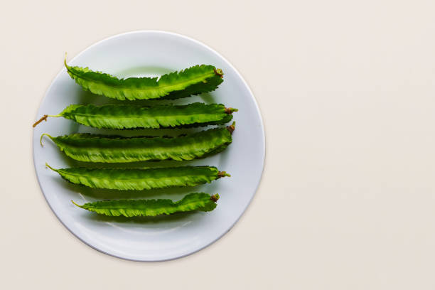istock top view fresh five winged bea vegetables on white dish on white background, vegetable, health, copy space 1383225103