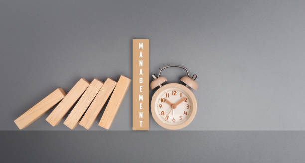 istock Text MANAGEMENT on wooden block task management clock over gray background. 1383225241