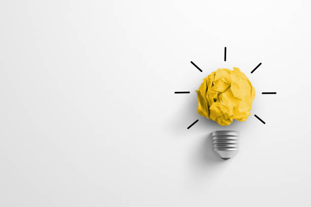 istock Creative thinking ideas and innovation concept. Paper scrap ball yellow colour with light bulb symbol on white background 1383229040