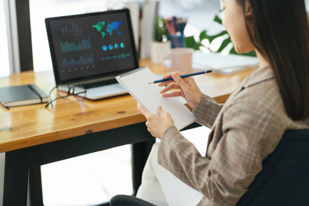 istock Business woman working with financial data hand writing make note with calculate. Business financial and accounting concept. 1383246513