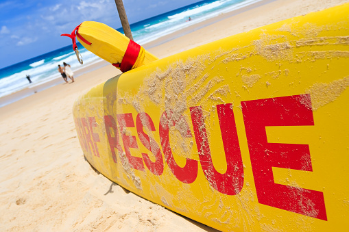 Yellow surf rescue board by the sea beach.