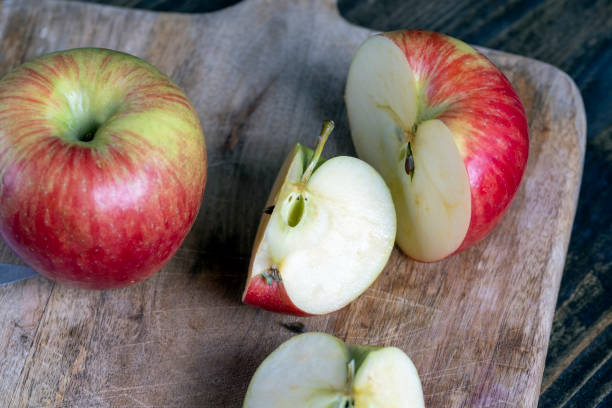 istock cutting old board with pieces of red ripe apple 1383294553