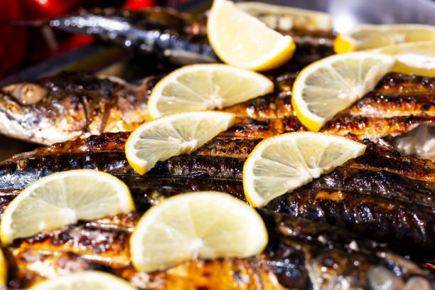 Grilled fish with lemon wedges