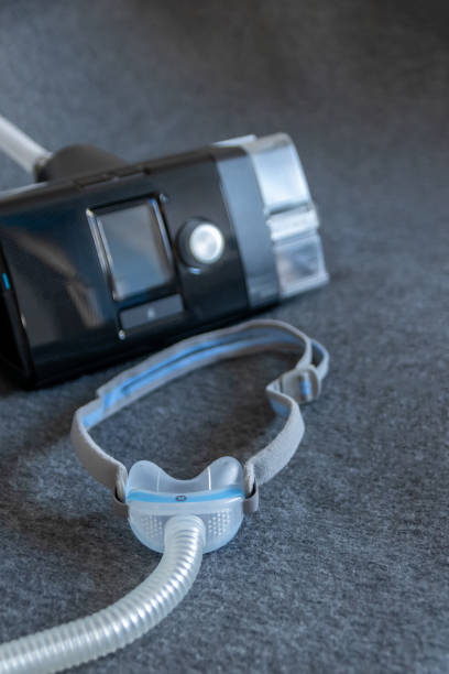 istock CPAP mask with a full face mask cpap machine against obstructive sleep apnea helps patients as respirator mask and headgear clip for breathing medication in snoring sleep disorder to breath easier 1383328417