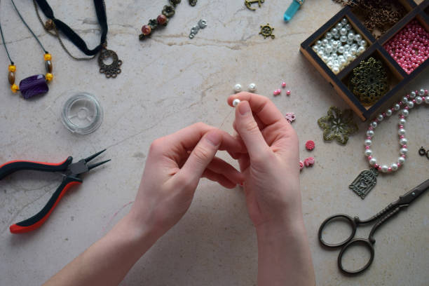 istock Making the jewelry. Needlework accessories for creating bracelet, chain from beads. DIY project. Small business. Income from hobby. 1383334807