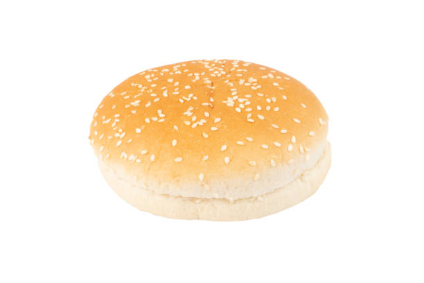 istock Fresh burger bun isolated on white background with clipping path. Sesame seed hamburger bun isolated on white. Top view. 1383369018