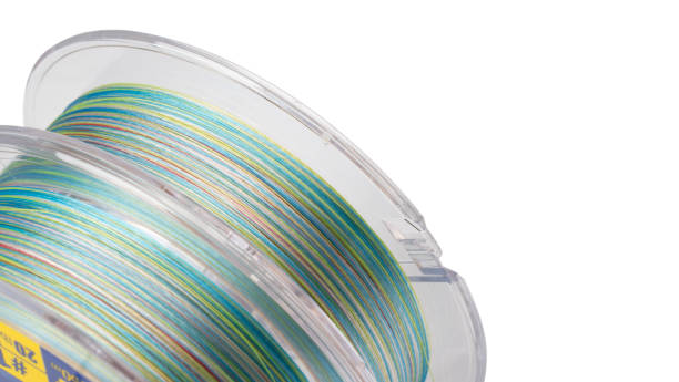istock Fishing braided line isolated on white background. Spool of multicolored cord isolated. Spool of braided fishing line. 1383370099