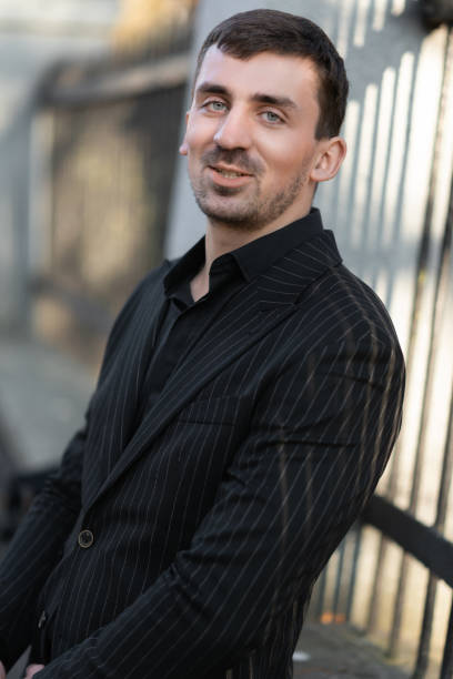 istock A young confident businessman is smiling and looking at the camera 1383385008