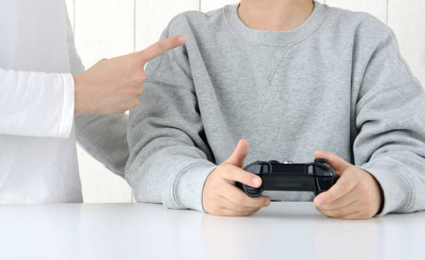 istock Mother scolding for child playing video game 1383386971