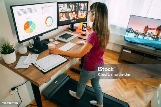 Woman At Standing Desk Home Office Talking On Business Video Call Stock Photo - Download Image Now
