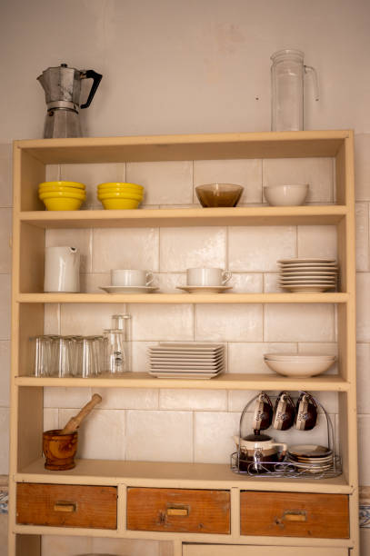 istock Kitchen cupboard with containers. Glasses, cups, coffee pot, jugs 1383390232