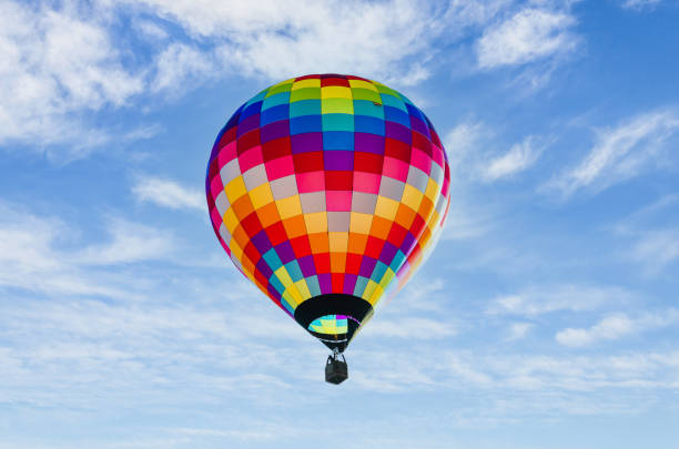 istock Hot air balloon flight over blue sky 1383393140