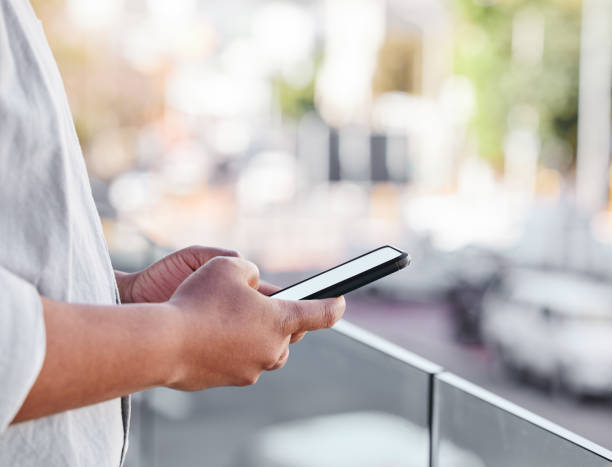 istock Shot of an unrecognisable man using a smartphone while standing on a balcony 1383393311