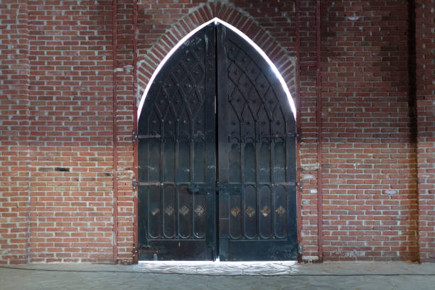 Close-up of the old black iron arched door