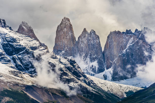 istock Torres del Paine peaks coming from clouds 1383393736