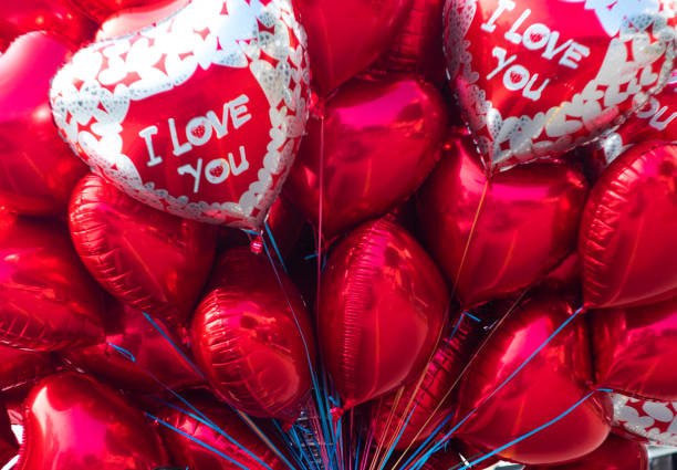 istock Red valentine balloons tied with ropes 1383395382