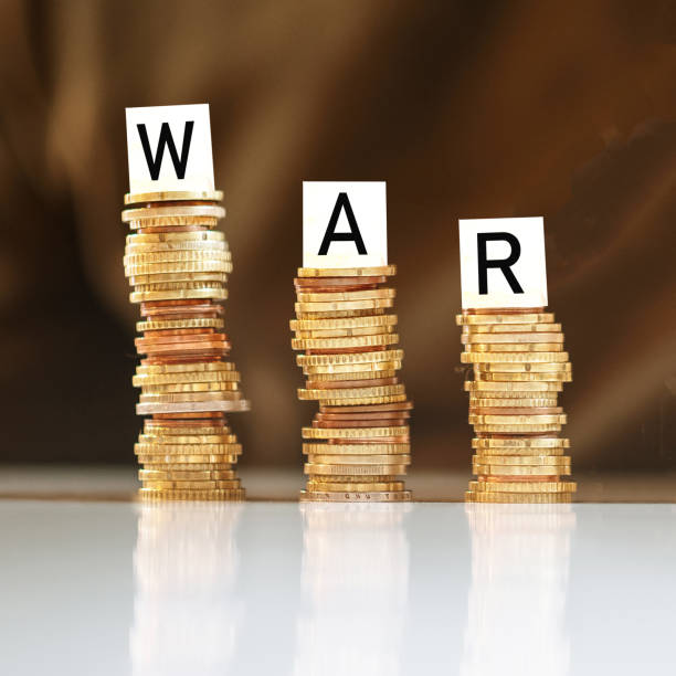istock Diminishing stacks of coins with War word written on them 1383401884