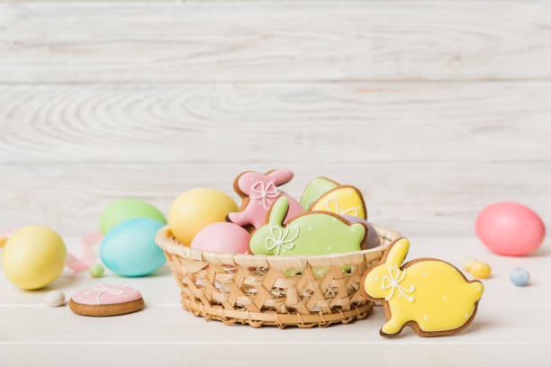 istock Colorful easter cookies in basket with Multi colors Easter eggs on colored background . Pastel color Easter eggs. holiday concept with copy space 1383404215