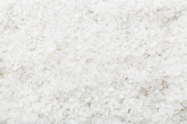 istock Background from white sea salt. Coarse rock salt texture witth copy space 1383404252