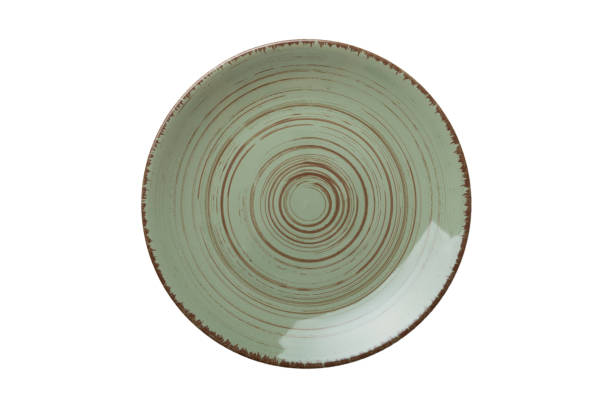 istock Green ceramic round plate isolated over white background. Top view 1383404291