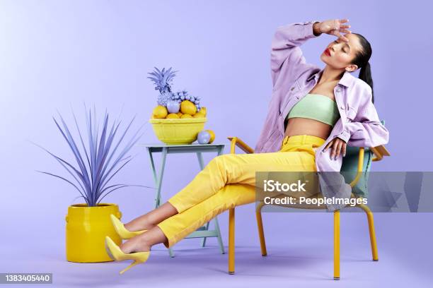 Full Length Studio Shot Of An Attractive Young Woman Dressed In Funky Attire Against A Purple Background Stock Photo - Download Image Now