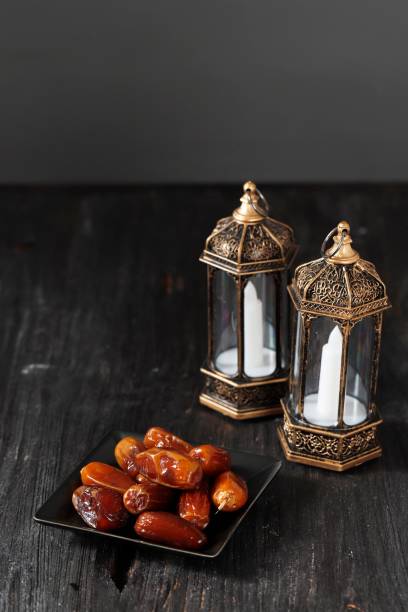 istock Selected Focus Lantern and Dates on Wooden Table. Ramadan kareem holiday celebration concept, 1383407665