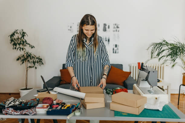 istock Young woman packing the products for shipment 1383408799