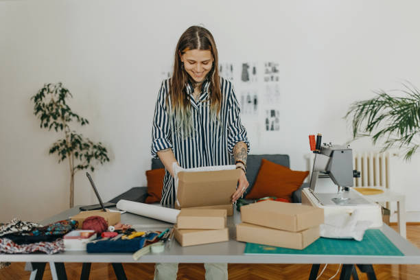 istock Young woman packing the products for shipment 1383408800