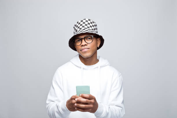 istock Portrait of confused young man using smart phone 1383409185