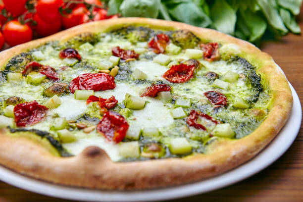 istock Pizza with basil sauce, dried cherry tomatoes, mozzarella  and parmesan 1383411591
