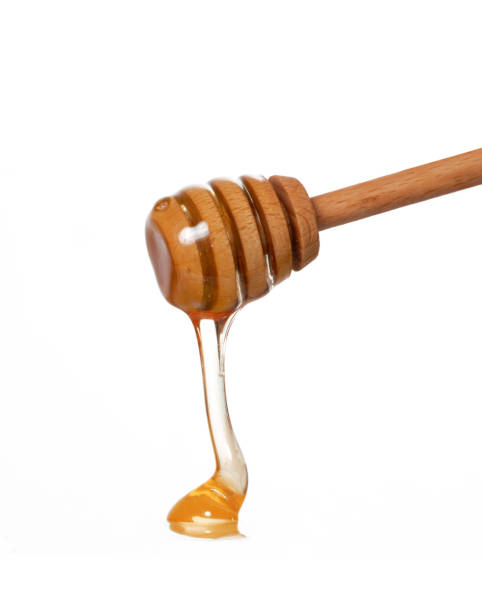 istock Wood honey dipper straining honey 1383412282