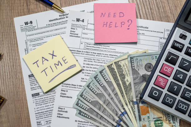 istock Form w4, w9 is empty to fill with money dollars on the table. 1383413636