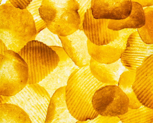 Potato chips, food background, backlit high angle view