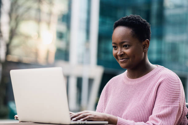 istock Young black woman studying outside on a laptop 1383416846