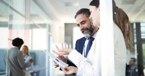 istock Business people having fun and chatting at workplace office 1383419005