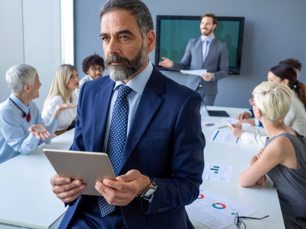 istock Handsome mature businessman, leader working in the office 1383419126