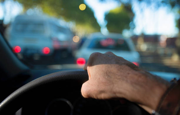 istock Car drives in rush hour traffic 1383419249