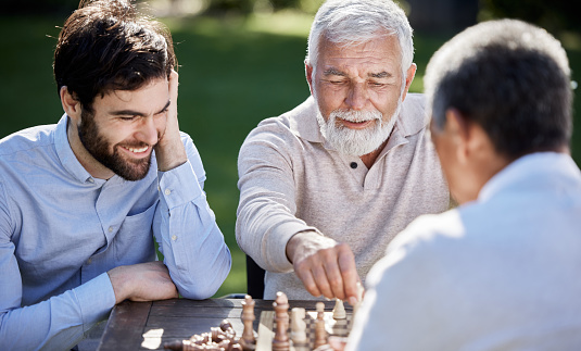 Sydney Australia - January 29 2011; Group mixed age men standing around large outdoor set set interacting and considering next move.