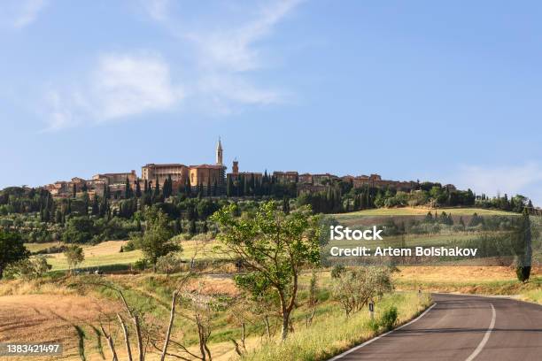 Road Winding Between The Green Hills Of Tuscany And Leading To The Medieval Town Of Pienza Stock Photo - Download Image Now