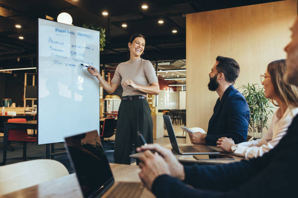 istock Cheerful business manager giving a presentation 1383422026